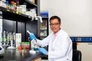 An image of JeeHwan holding a multichannel pipette.